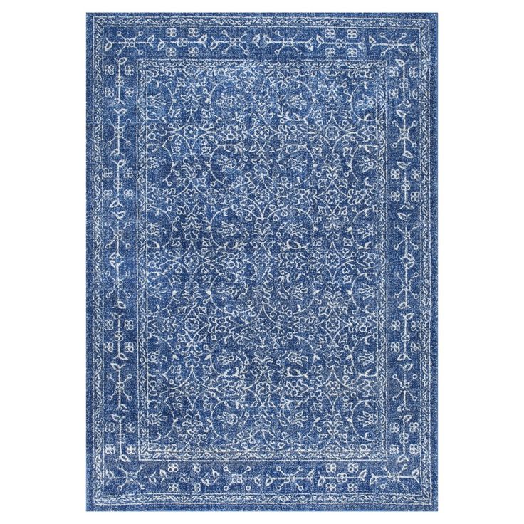 a blue and white rug with an intricate design on the bottom, in front of a white background