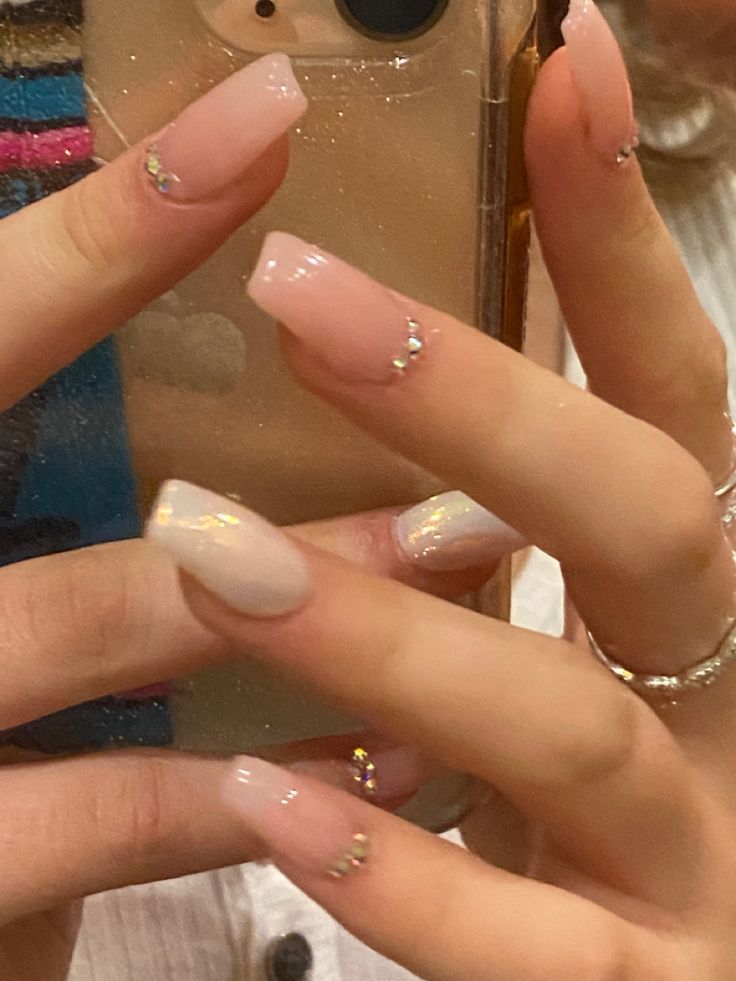 a woman holding up her phone to take a selfie with her manicured nails