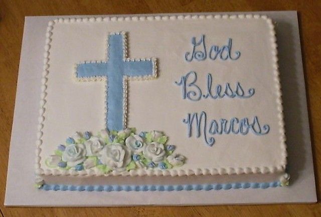 a cake that is decorated with flowers and a cross on the top it says, god bless mangers