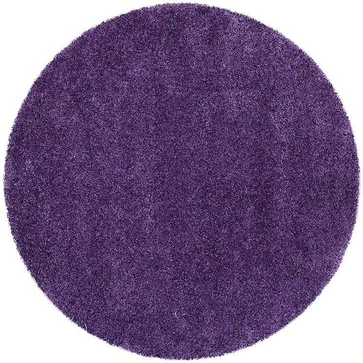 a round purple rug is shown on a white background and it looks like the area has been