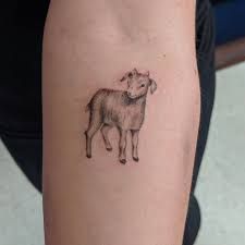 a small tattoo of a sheep on the arm