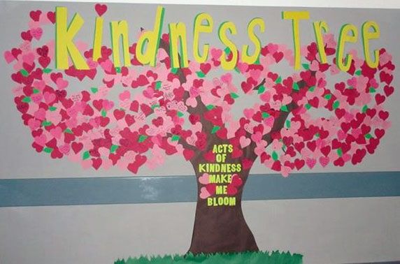 a bulletin board with a tree made out of paper hearts and the words kindness tree written on it