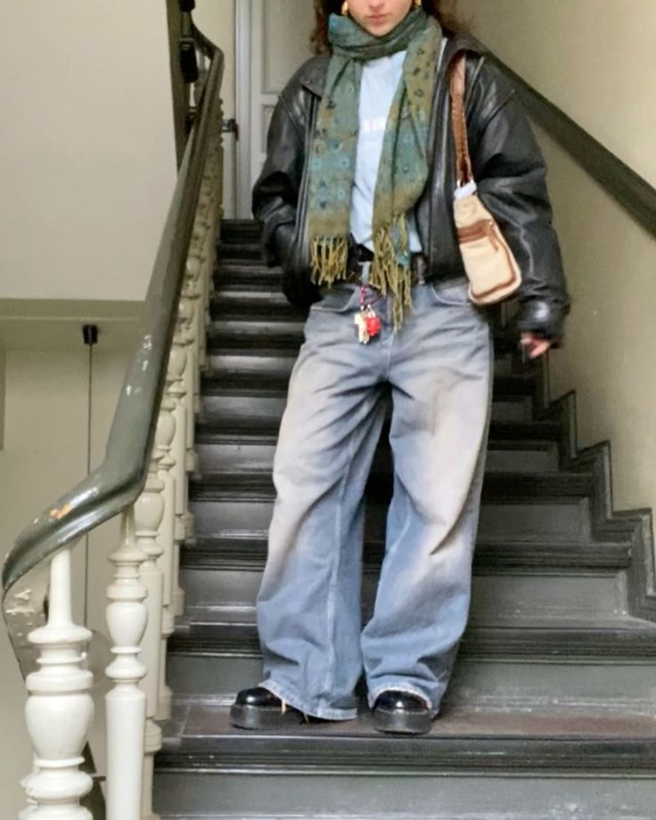 a woman is standing on the stairs with her hand in her pocket