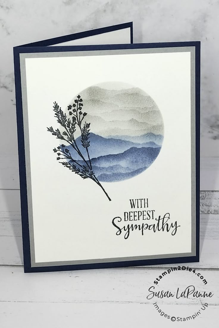 a handmade sympathy card with watercolor mountains in the background and text that reads, with deepest sympathy