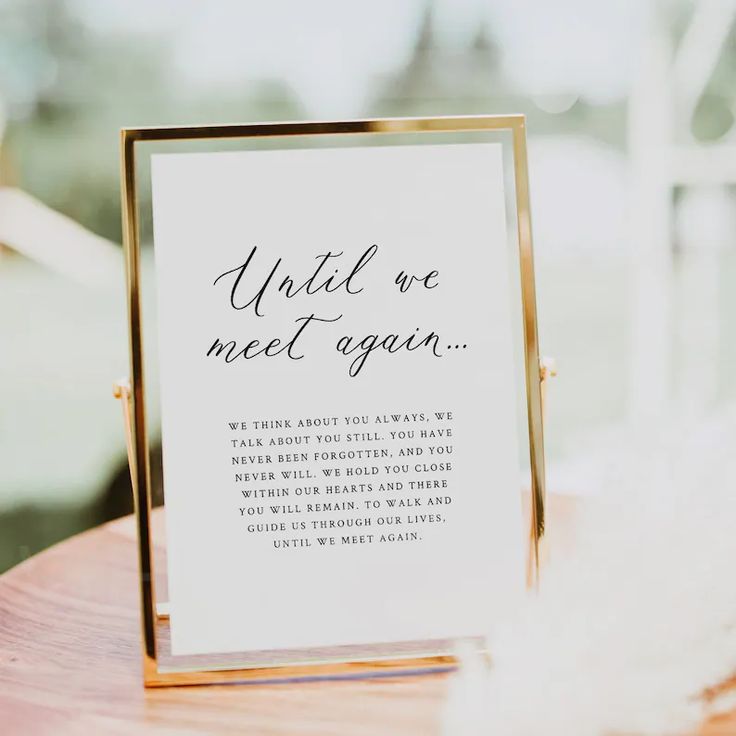 a sign that says in loving memory on it sitting on top of a wooden table