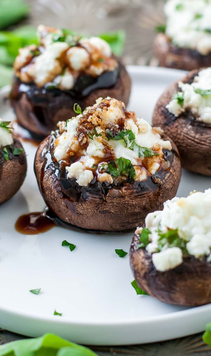 stuffed mushrooms with cheese and herbs on a plate