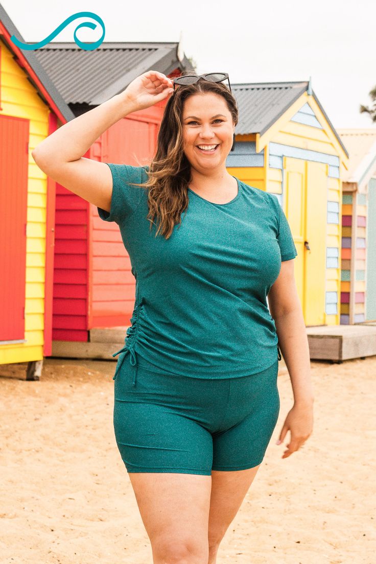 Transform your beach game with our stunning Plus Size Adele Swim Top and Mid-Thigh Swim Shorts. This ensemble offers a tight fit. The swim top has a side ruching for a flattering cinched appearance, short sleeves, and a round neckline. The swim bottom has high-waisted shorts and a wide waistband. Make a splash in style! Follow Calypsa for cute plus-size swimming outfits! Modest Plus Size, Swim Capris, Swimming Outfits, Plus Swim, Swim Skort, Crop Swim Top, Athletic Swim, Swim Leggings, Swim Bra