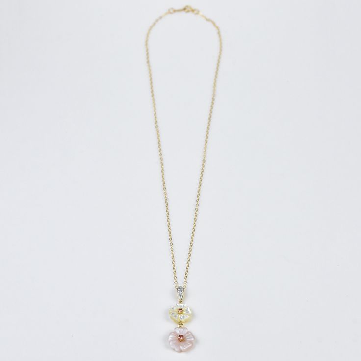 Pale pink and ivory Mother of Pearl flowers Two round brilliant Pink Tourmaline stones Round brilliant diamonds with a total of 0.005 cts 14 karat yellow gold 14ky gold flat cable chain, 1.5mm wide, 16 inches long Matching ring available Goldmakers Jewelry Mission Statement Goldmakers Jewelry creates and curates a comprehensive selection of artfully designed hand-crafted jewelry out of our Lawrence, Kansas studio and boutique. We aspire to offer the jewelry enthusiast access to affordable classi Delicate Pink Jewelry With Rose Cut Diamonds, Pink 14k Gold Jewelry With Single Cut Diamonds, Dainty Pink Jewelry With Rose Cut Diamonds, Elegant Pink Jewelry With Cable Chain, Elegant Pink Cable Chain Jewelry, Dainty Pink Rose Cut Diamond Jewelry, Pink Fine Jewelry With Single Cut Diamonds, Pink Single Cut Diamond Fine Jewelry, Fine Jewelry In Pink Gold With Rose Cut Diamonds