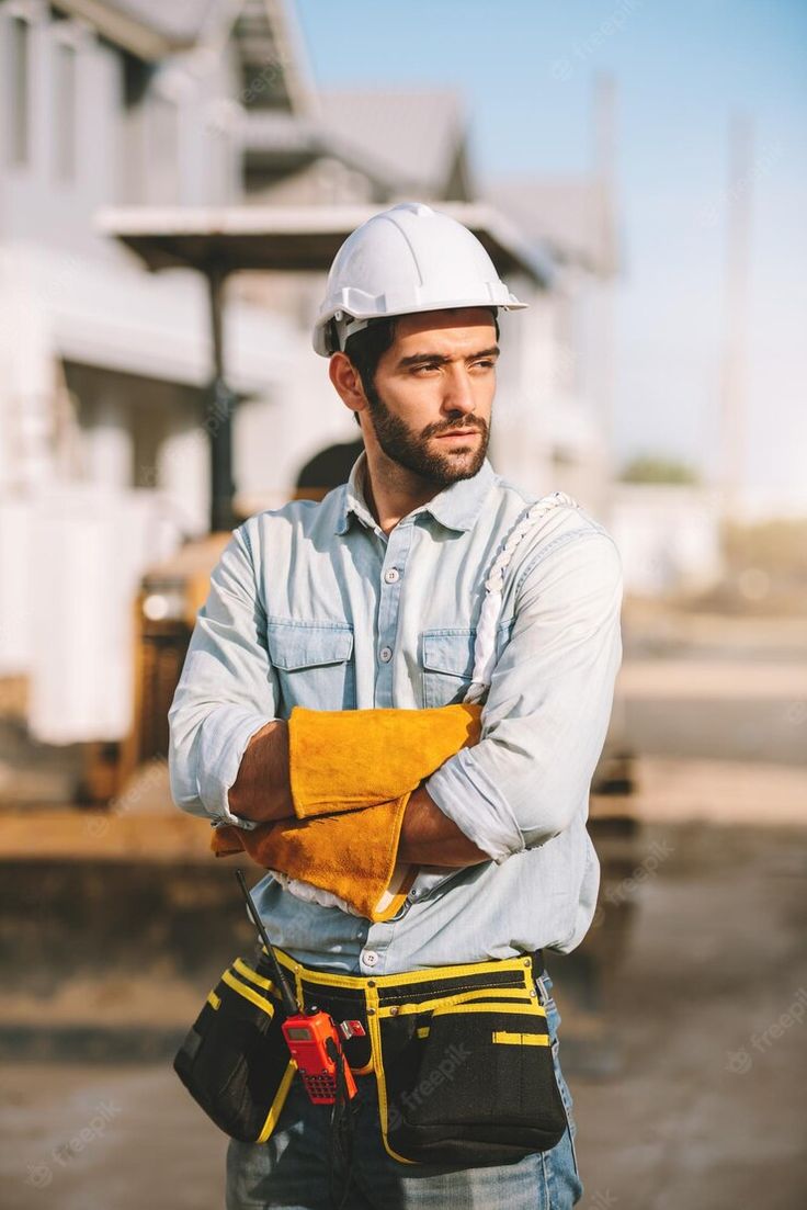 a construction worker standing with his arms crossed