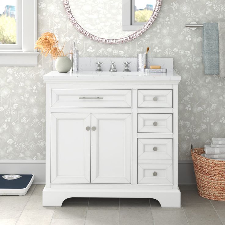 a white bathroom vanity with a mirror above it