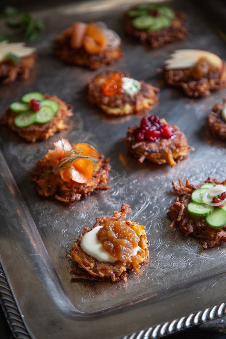 a metal tray topped with cookies covered in toppings