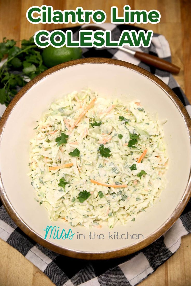 a white bowl filled with coleslaw on top of a wooden table