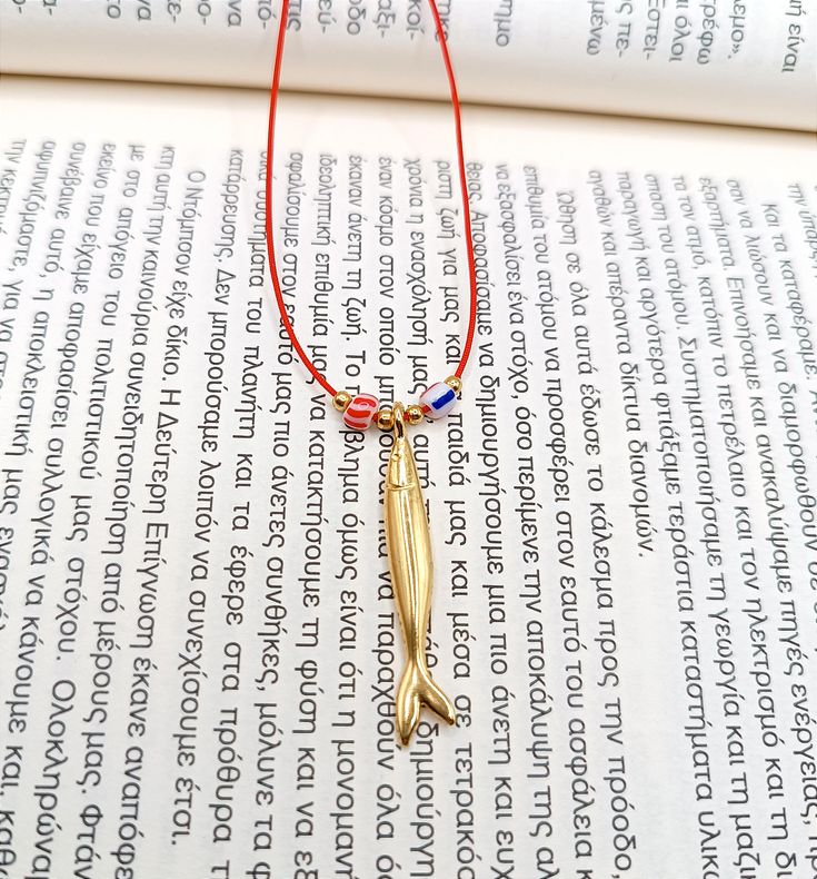 Sardine fish necklace, gold plated charm, Beach jewelry Summer gift ideas Sea lover gift Simple string choker Nautical gifts Unisex gift for sea lovers! A Unique Necklace that's dainty, minimal and versatile, but most importantly, special and meaningful! Fish are symbols of rebirth, fertility, the unconscious or higher self, luck, change, health, and feelings. DETAILS Metal: Zamak with  24k gold plated over zamak charm and gold plated beads Total length 28" Cord: 1mm chinese nylon cord Size is a Amulet Style Charm Necklace With Adjustable Chain As Gift, Gold Jewelry With Adjustable Cord Gift, Amulet Charm Necklace With Adjustable Chain As Gift, Adjustable Gold Charm Necklace For Gifting, Adjustable Gold Charm Necklace As A Gift, Adjustable Gold Charm Necklace For Gifts, Gold Necklace With Adjustable Cord For Gift, Adjustable Amulet Charm Necklace As Gift, Amulet Charm Necklaces With Adjustable Chain For Gift