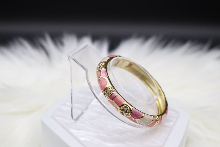 The Pink Enamel Bangle Hinged Bracelet is a charming and elegant accessory, showcasing a soft pink enamel finish that exudes a sense of grace and sophistication. Its hinged design provides ease of wear and removal, making it a versatile addition to your jewelry collection, perfect for adding a touch of femininity to your outfits. Enamel Bangle, Hinged Bracelet, Pink Enamel, Green Enamel, Elegant Accessories, Pink Bracelet, Christmas Sale, The Pink, Soft Pink