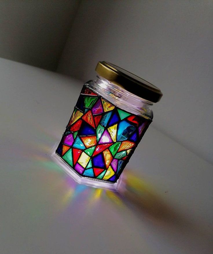 a glass jar with a colorful mosaic design on it