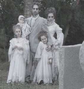 a group of people standing next to each other in front of a statue and trees