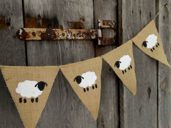 a brown and white banner with sheep on it hanging from an old door frame,