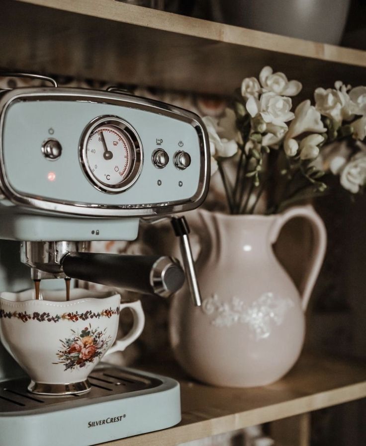 a coffee maker sitting on top of a wooden shelf