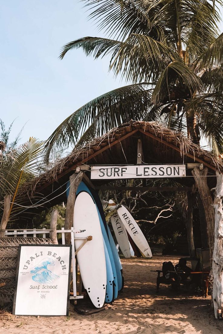 several surfboards are lined up in front of a sign that says surf lesson on it