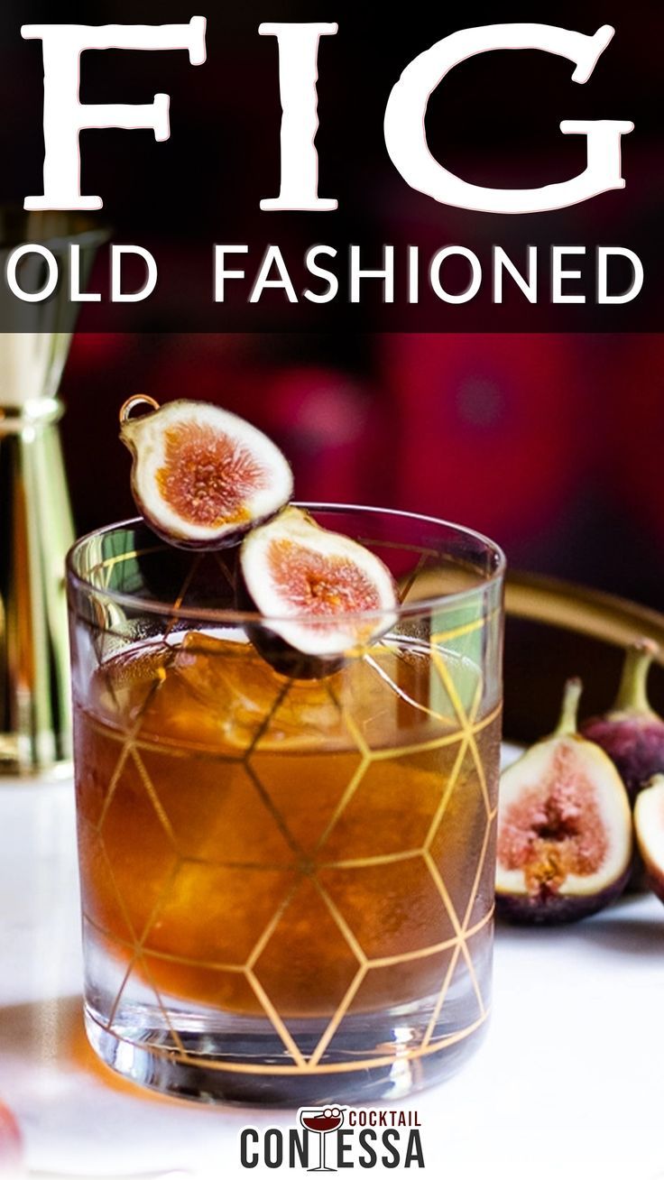 fig old fashioned cocktail with fresh figs in the background