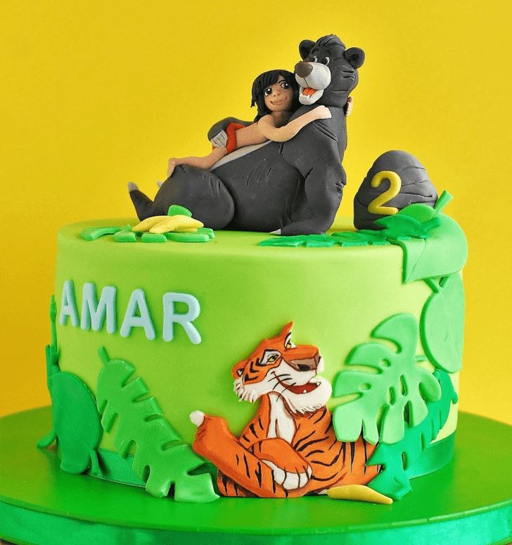 a birthday cake decorated with an image of two people on top of a jungle animal