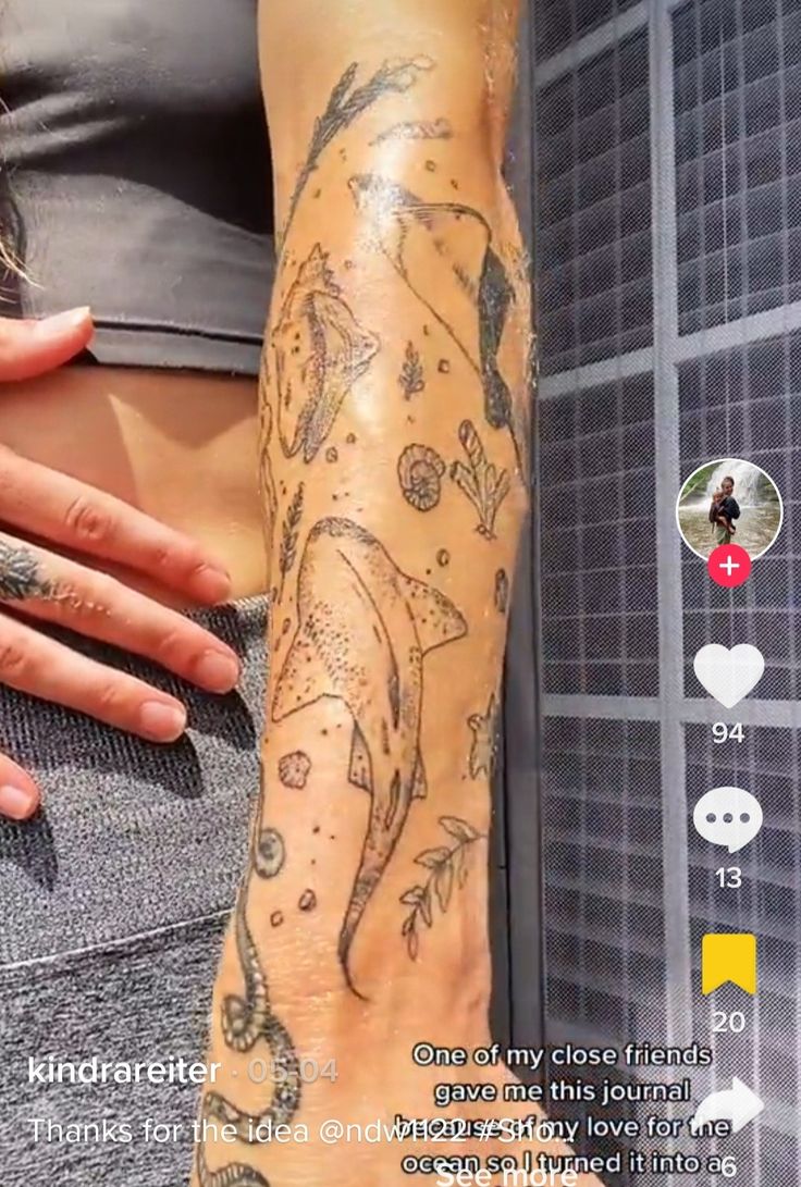 a woman's arm with tattoos on it