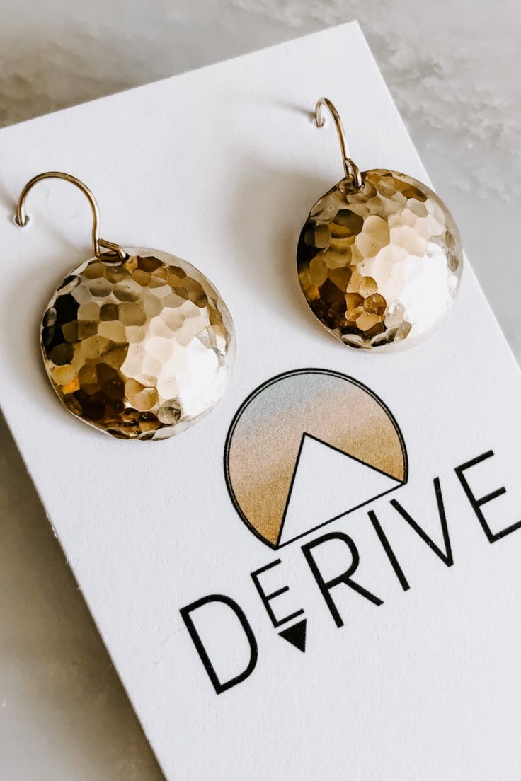 These earrings are a great everyday piece. Hand hammered and domed 14k gold fill or sterling silver - quality to last! Check these out and more and follow us on instagram @derive_jewelry Adjustable Hammered 14k Gold Earrings, Minimalist Hammered Bronze Earrings, Modern Hammered Circle Earrings, Gold Moon Phase Earrings In Sterling Silver, Gold Sterling Silver Moon Phase Earrings, Hammered Brass Round Disc Earrings, Gold Minimalist Earrings With Moon Phase, Moon Phase Brass Earrings, Gold Moon Phase Round Earrings