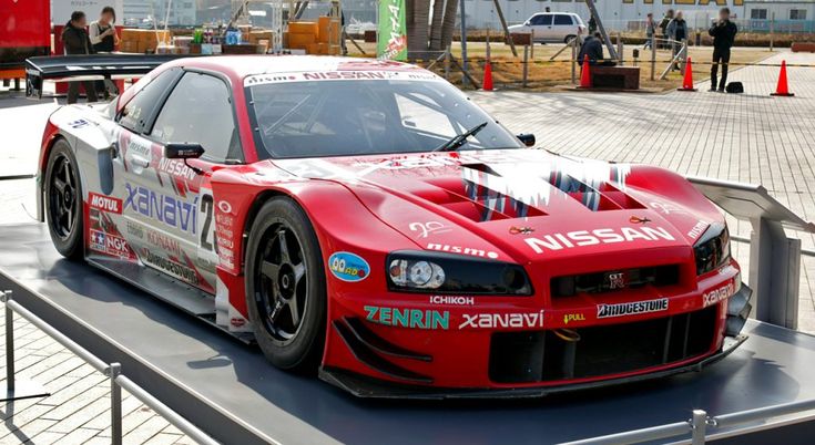 a red sports car on display at an event