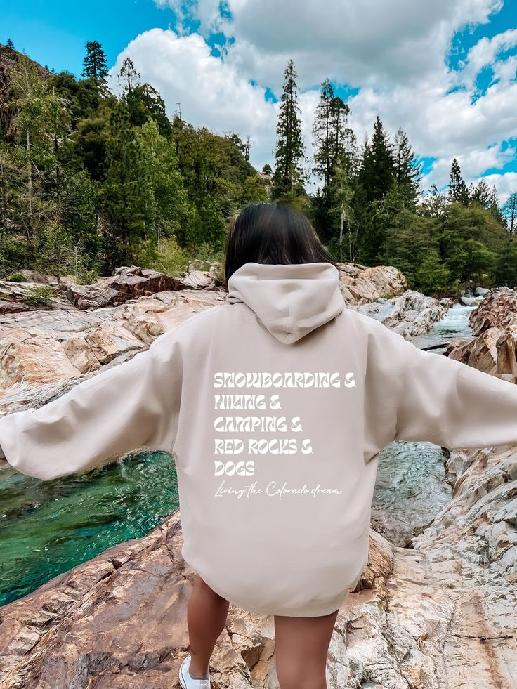 How do you live the Colorado dream? Here in Colorado, we really love our hobbies. Celebrate all that Colorado has to offer with this fun hoodie listing out the best ways to experience the magic experienced in our amazing state: Snowboarding, Hiking, Camping, Red Rocks, and Dogs!  This hoodie is NOT oversized, so please size up if you want a looser fit! If you like the oversized fit, I recommend choosing 2-3 sizes up. For example: if you use size S choose between L or XL. Love your hoodie!? I'd greatly appreciate a review with a photo to help my shop!! Thank you for your support! Front reads:  Living the Colorado dream Back reads:  Snowboarding & Hiking & Camping & Red Rocks & Dogs Living the Colorado dream This unisex heavy blend hooded sweatshirt is relaxation itself. Made with a thick bl You Deserve The World, Shark Hoodie, Sweatshirt Aesthetic, Aesthetic Hoodie, Country Shirts, Colorful Hoodies, Favorite Jeans, Rodeo, Evil Eye