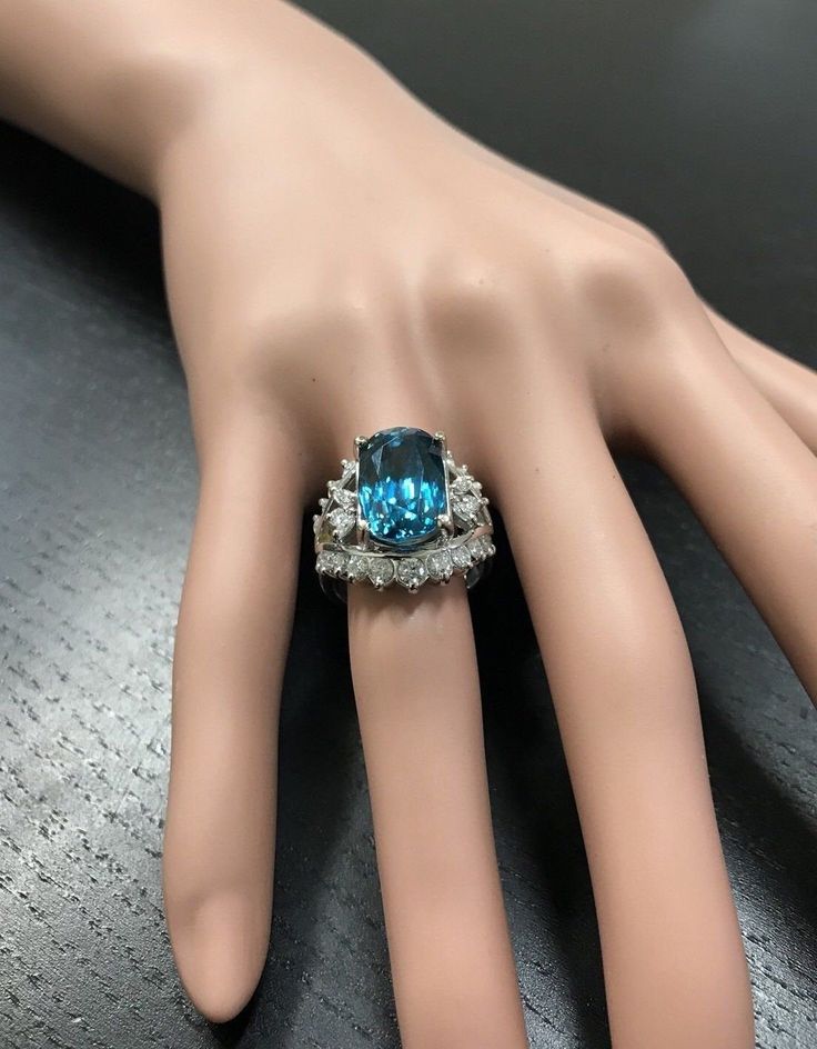 13.50 Carats Natural Very Nice Looking Zircon and Diamond 14K Solid White Gold Ring Suggested Replacement Value: Approx. $8,300.00 Total Natural Cushion Cut Zircon Weight is: Approx. 12.00 Carats Zircon Measures: Approx. 13.00 x 9.00mm Natural Round & Marquise Diamonds Weight: Approx. 1.50 Carats (color G-H / Clarity SI1-SI2) Ring total weight: Approx. 10.00 grams Disclaimer: all weights, measurements and colors are approximate and may vary slightly from the listed dimensions or as seen in t Luxury Blue Topaz Ring Gia Certified, Formal Blue Topaz Platinum Ring, Formal Blue Topaz Ring With Diamond, Blue Platinum Jewelry For Collectors, Blue Platinum Jewelry Collectible, Elegant Gia-certified Blue Topaz Jewelry, Elegant Gia Certified Blue Topaz Jewelry, Dazzling Aquamarine Rings For Formal Occasions, Collectible Blue Platinum Jewelry