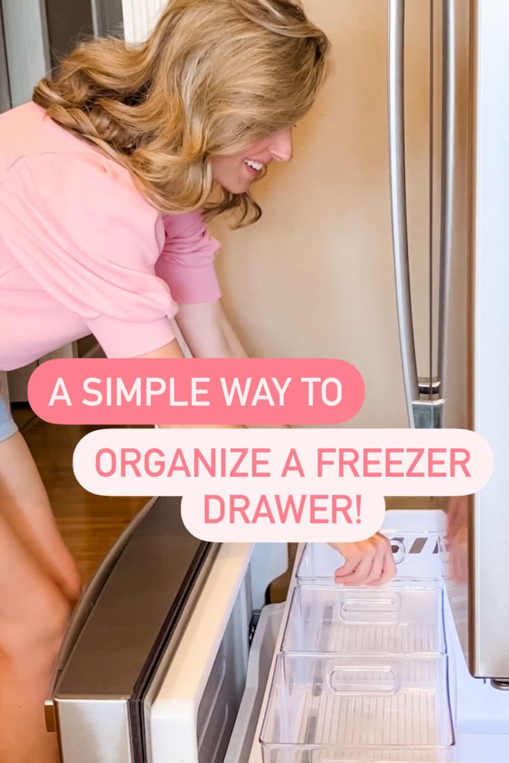 a woman is looking into the freezer drawer