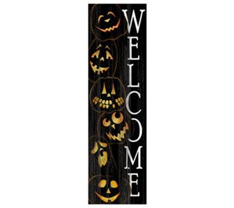 a welcome sign with pumpkins and jack - o'- lantern faces on it