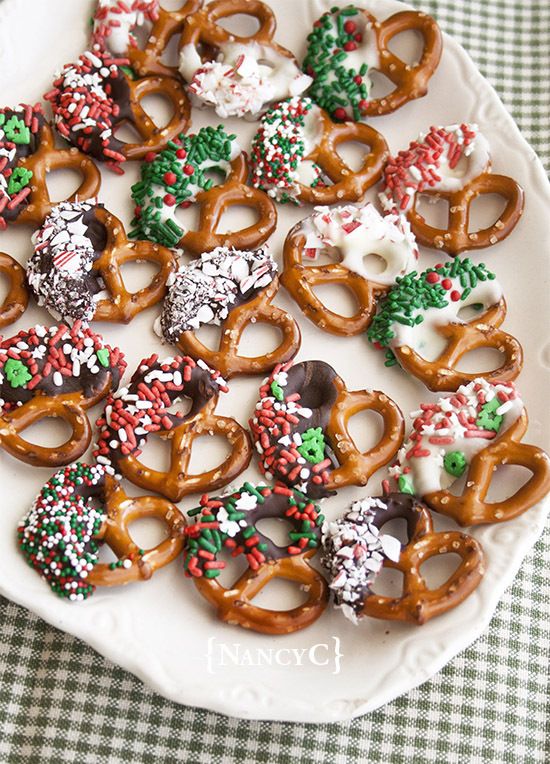 a white plate topped with lots of pretzels and cookies