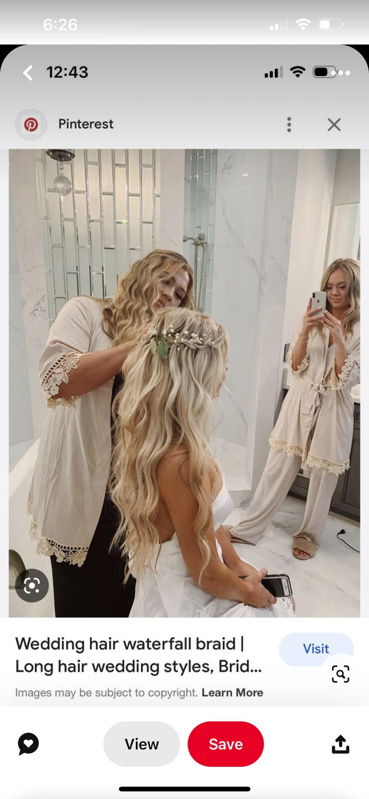 a woman is taking a selfie in front of a mirror with her wedding hair