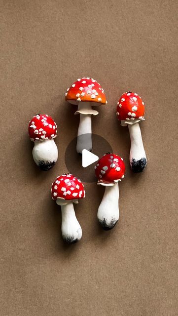 small red and white mushrooms sitting on top of a table