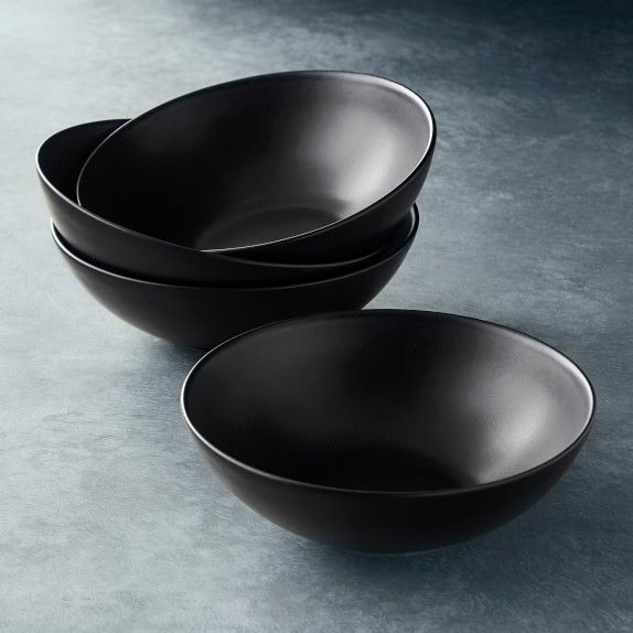 three black bowls sitting on top of a table