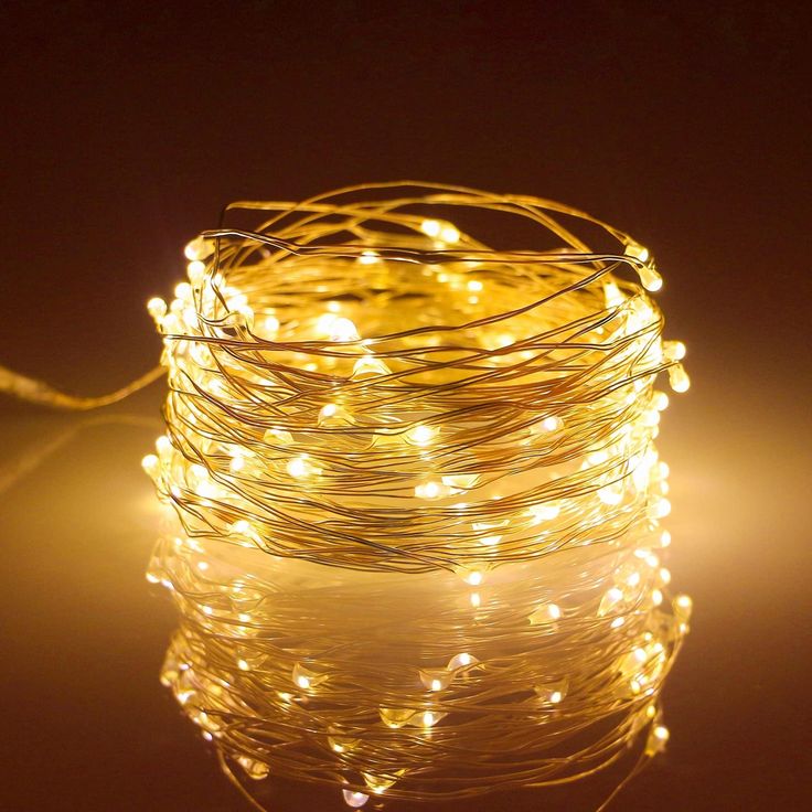 some lights that are sitting on top of a table in front of a dark background