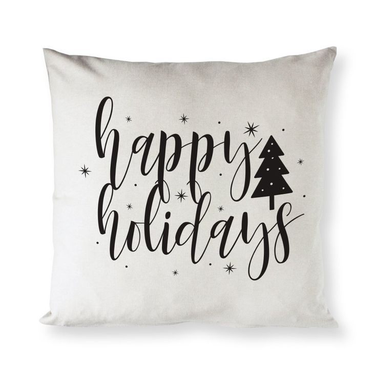 a white pillow with the words happy holidays on it and a christmas tree in black lettering