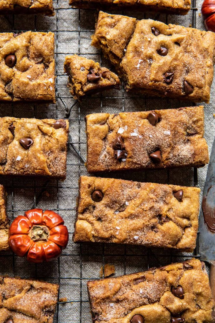 chocolate chip cookie bars cooling on a wire rack with tomatoes and a knife next to them