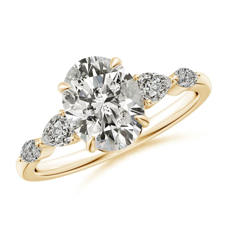 a yellow gold engagement ring with three pear shaped diamonds on the shoulders and side stones