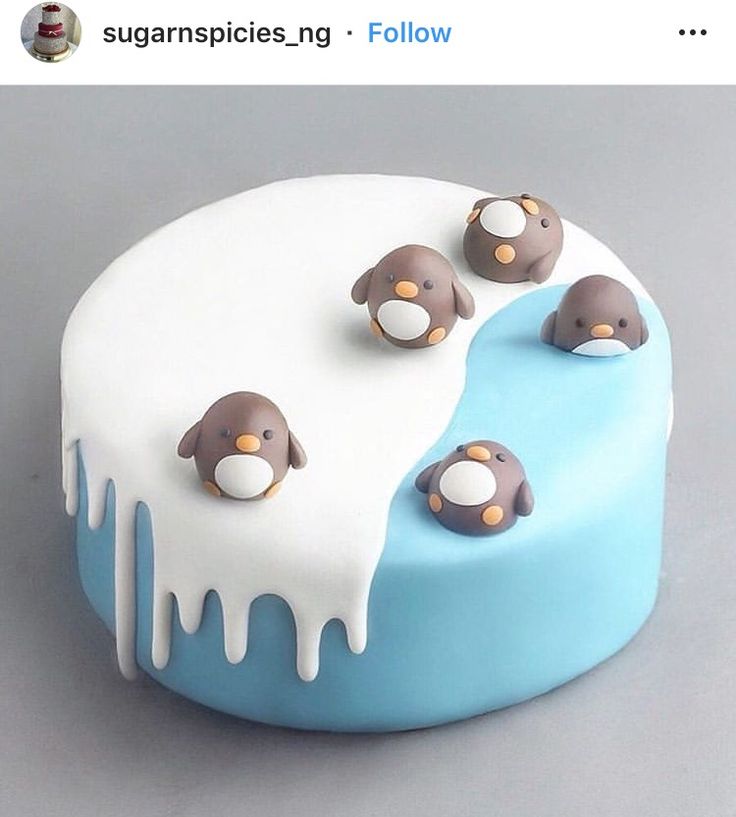 a cake decorated with penguins and melting icing