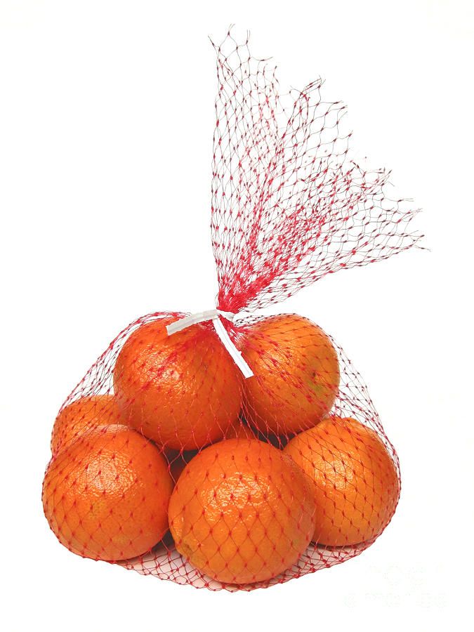 a bag full of oranges sitting on top of each other