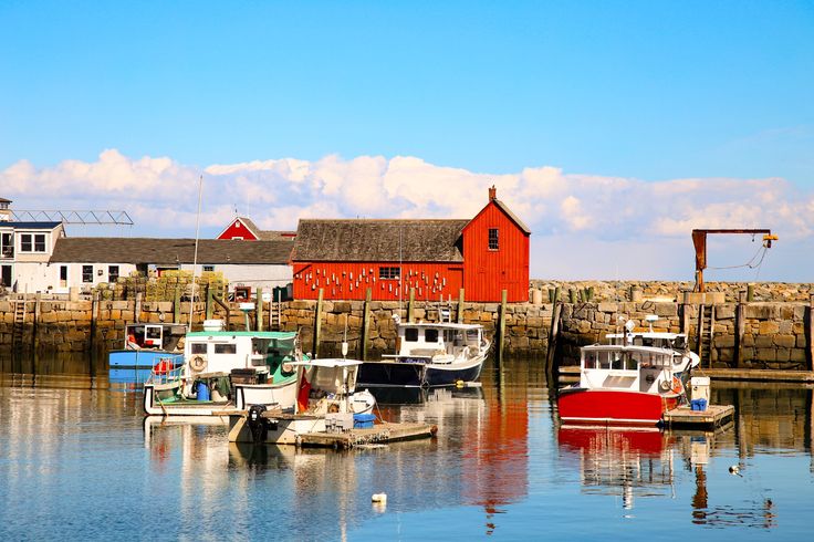 there are many boats that are in the water near each other and one is red