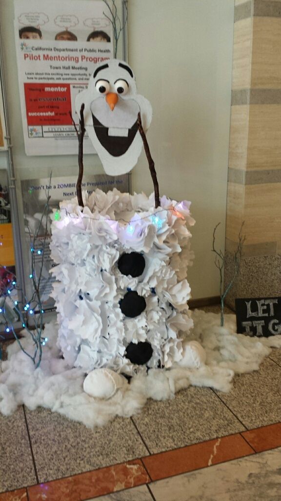 a fake snowman made out of paper mache and other items on the floor