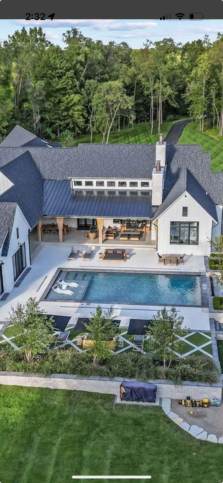 an aerial view of a large house with a swimming pool in the middle of it