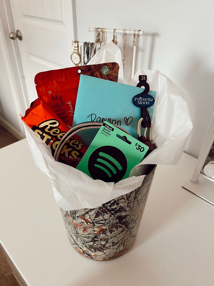 a bucket filled with assorted items sitting on top of a white counter next to a door