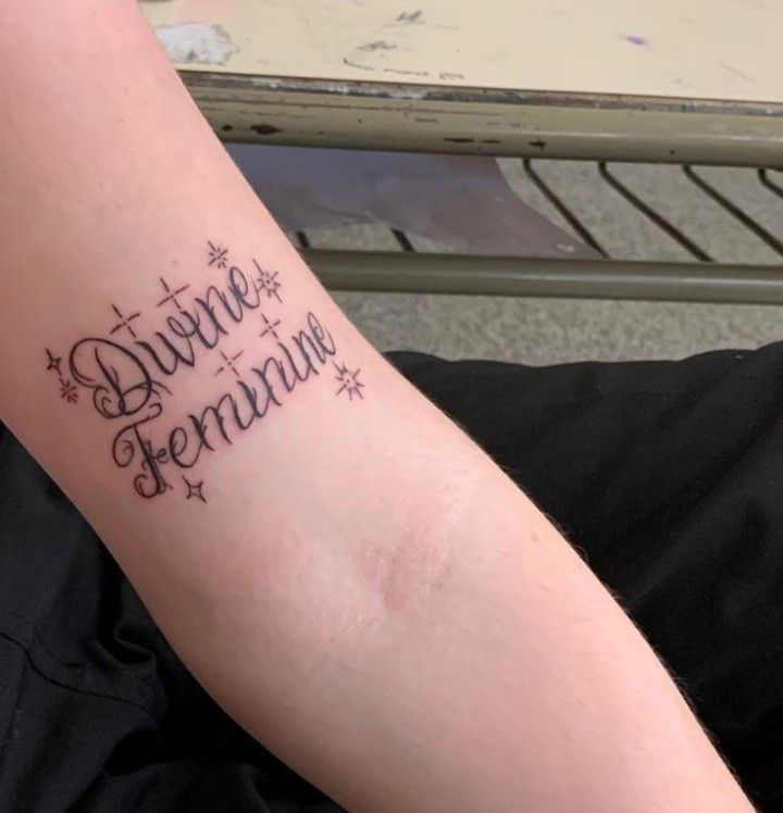 a woman with a tattoo on her arm that says, dance bernaun and stars