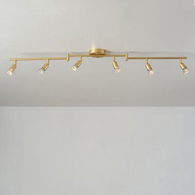 a ceiling light with five lights on each side and four bulbs in the middle, against a white wall