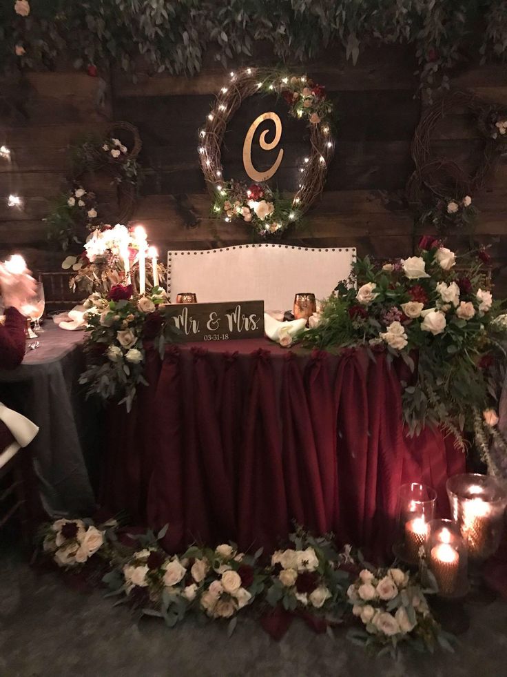 a decorated table with candles and flowers on it in front of a sign that reads 9