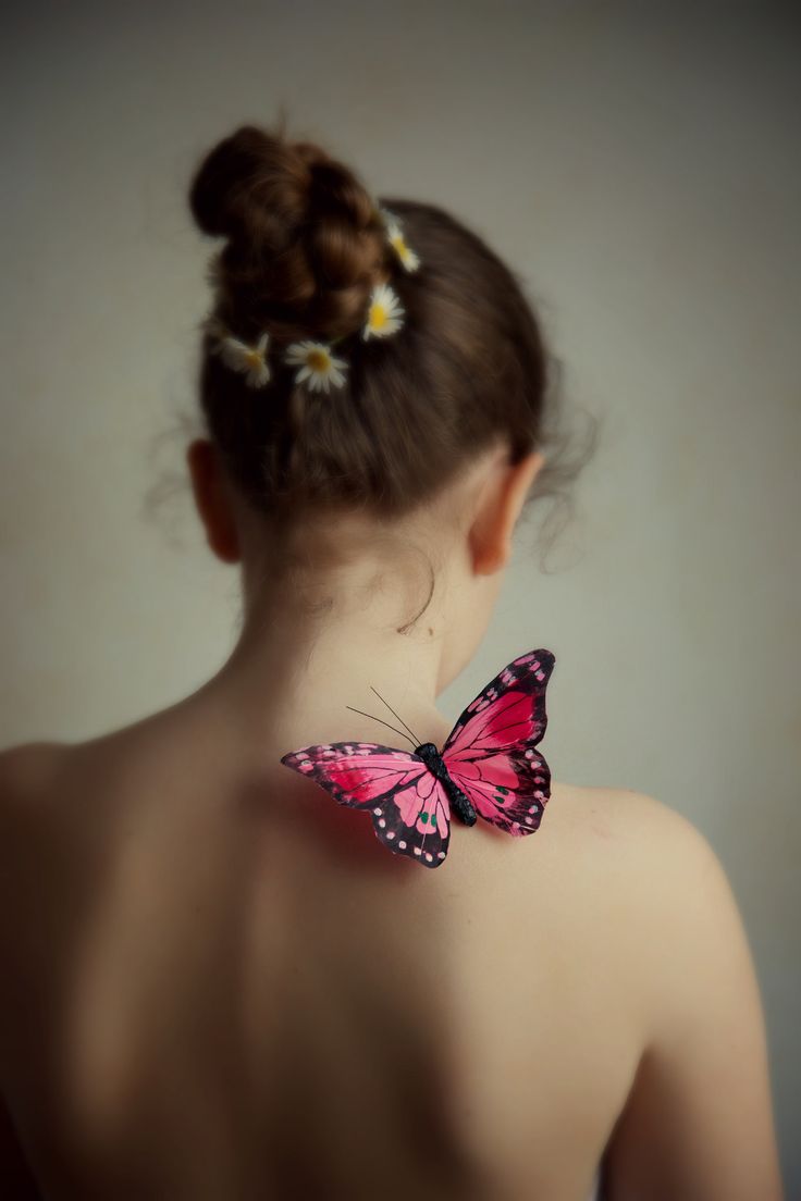 a woman with a pink butterfly on her back